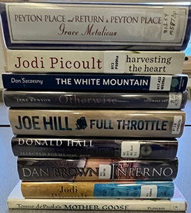 stack of books by NH authors